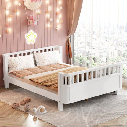 White children's bed with brown bedding in a room with pink walls and large windows.
