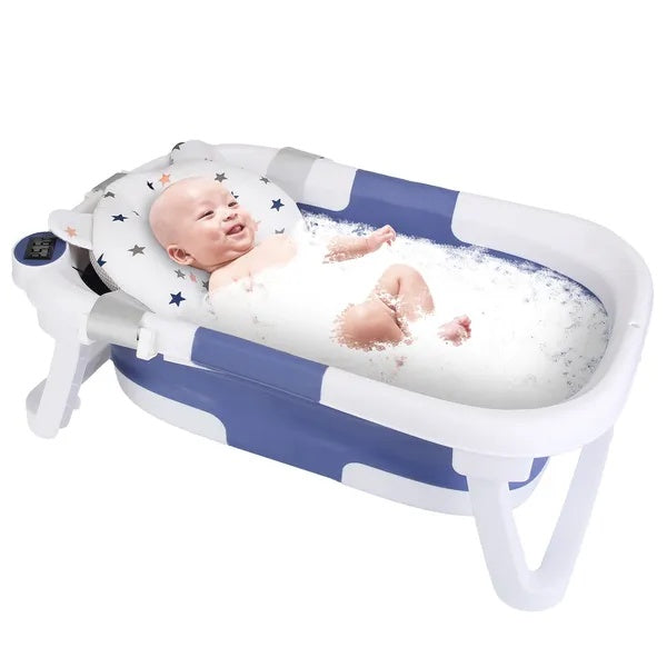 Baby in a inflatable bathtub with bubbles on a white background