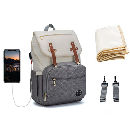 Gray backpack with white compartment, phone, blanket, and straps on a white background