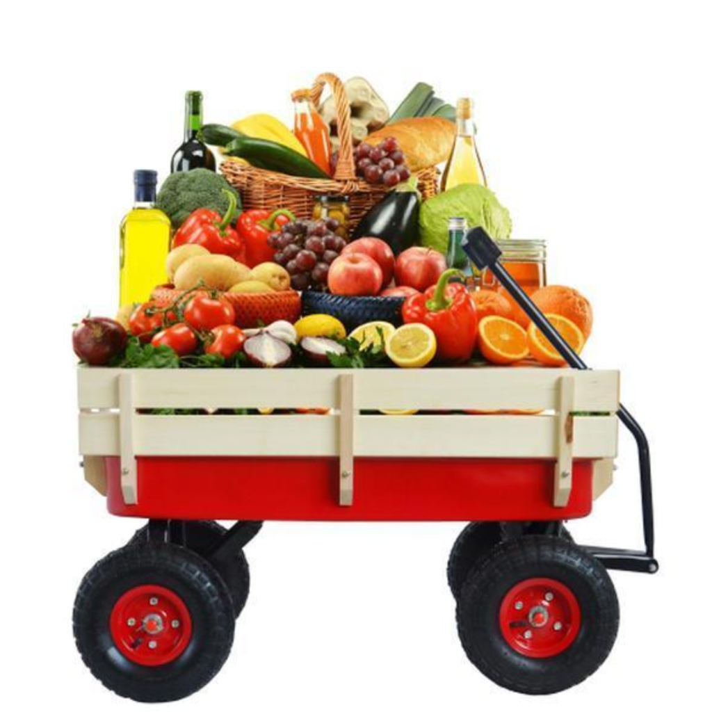 Red wagon filled with a variety of fruits and vegetables on a white background