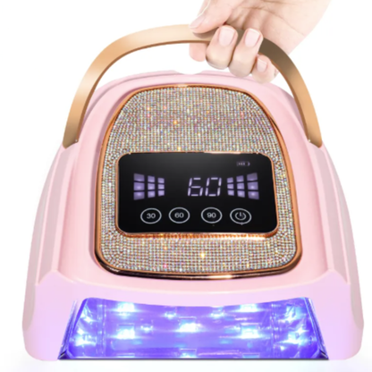 Pink electronic device with digital display and handle, held by a hand.